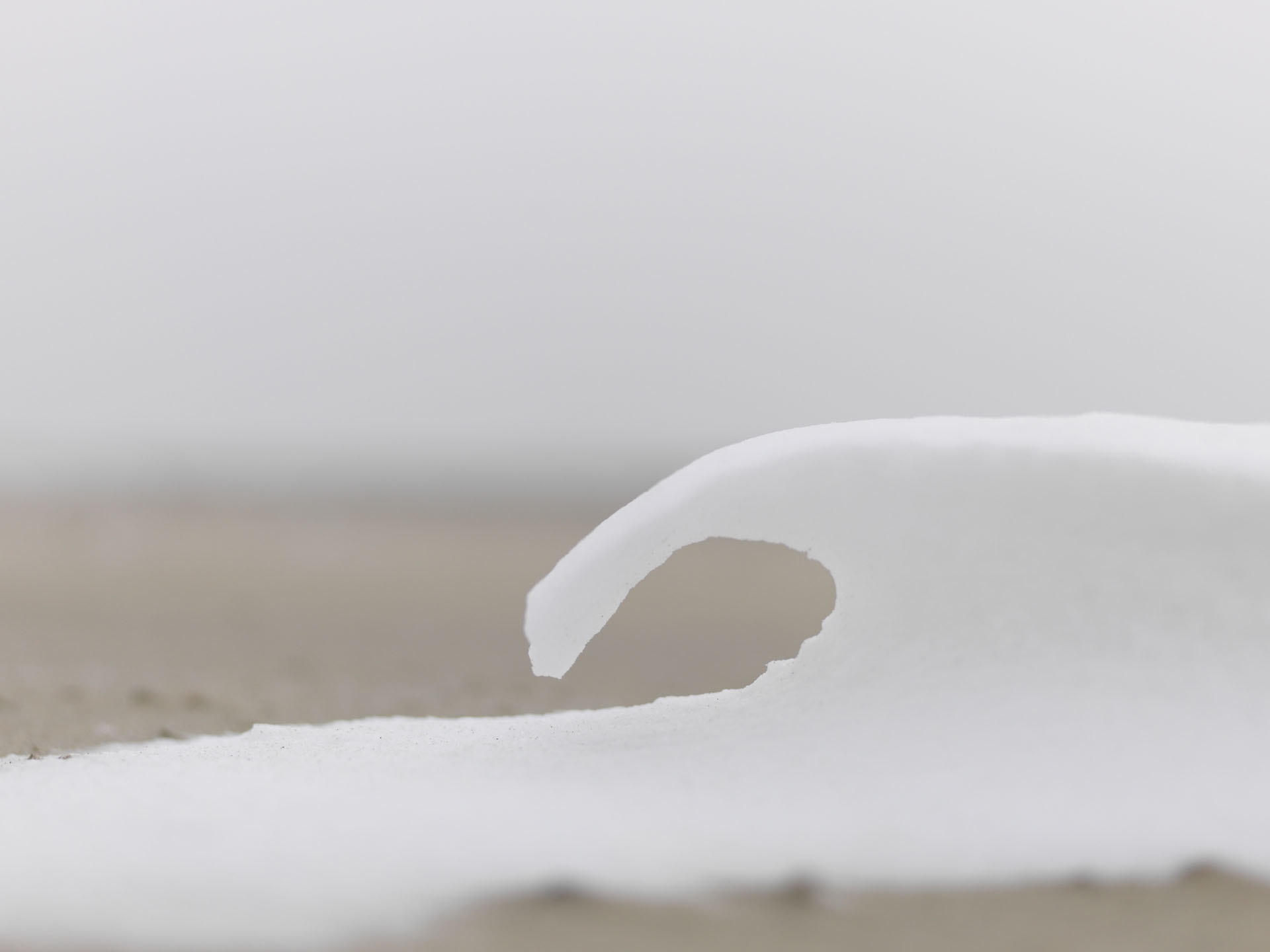 Curved overhang of white snow