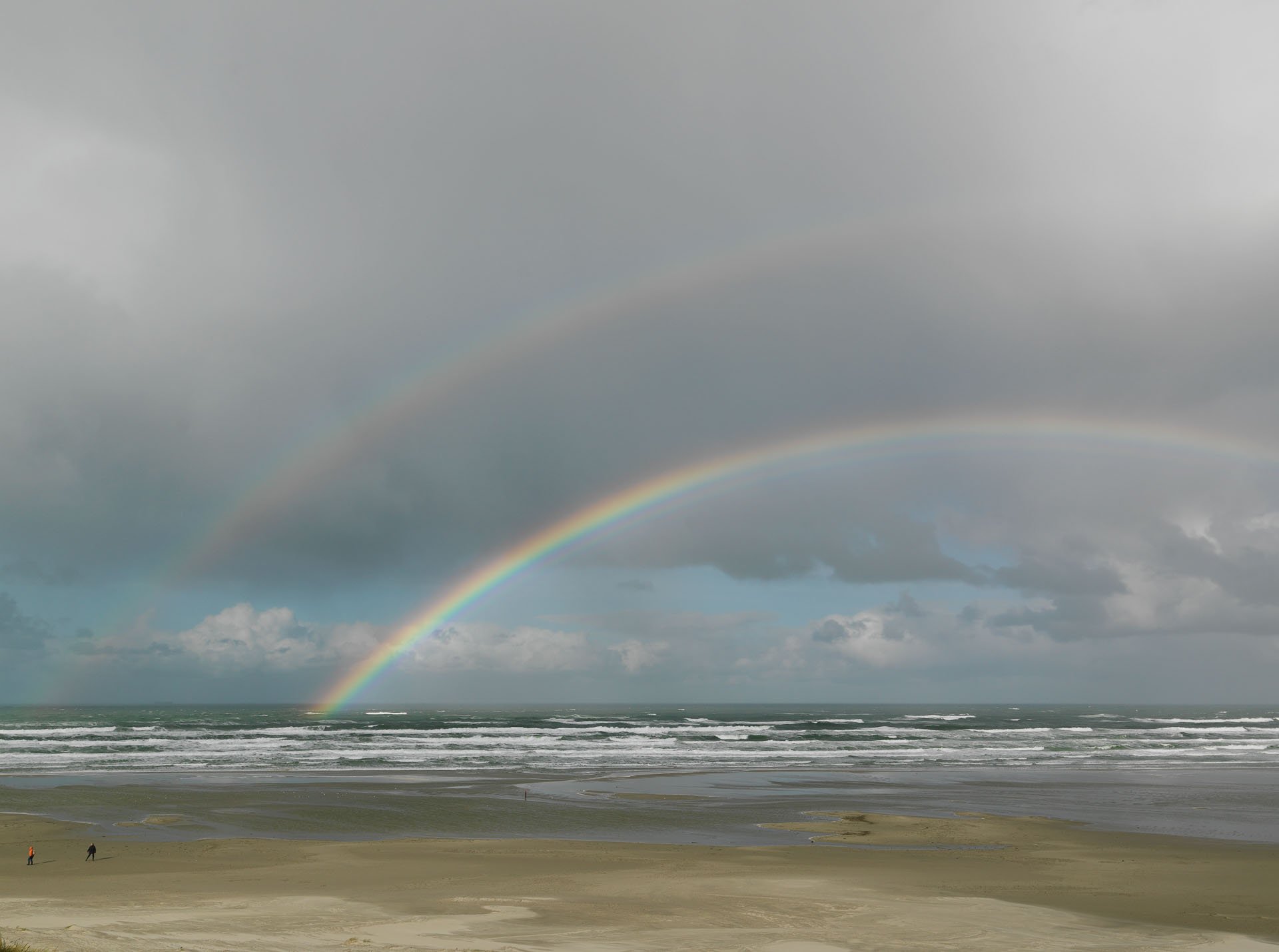 Double rainbow above the sea and beach