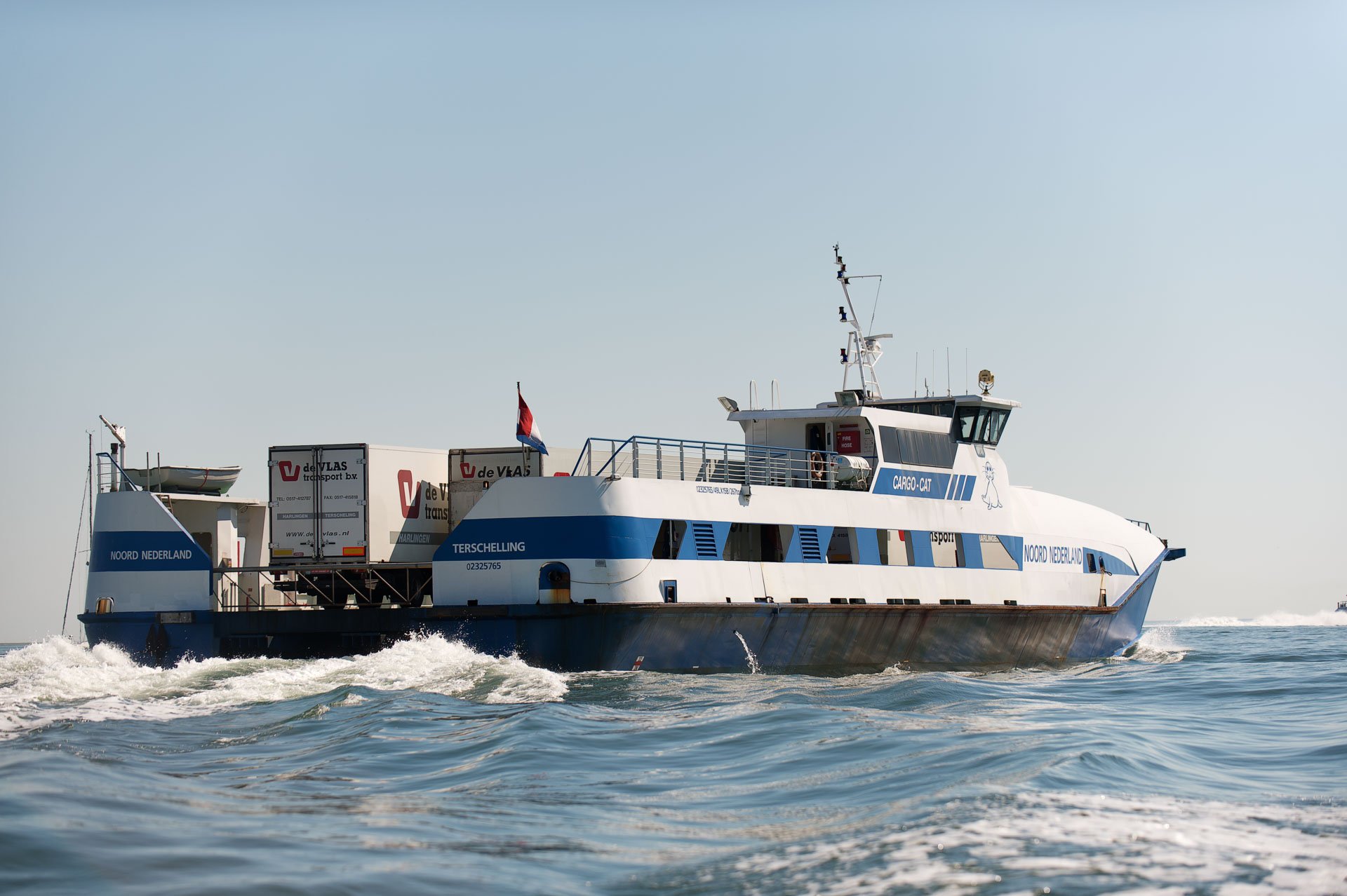 Ferry sailing away with a foaming wake