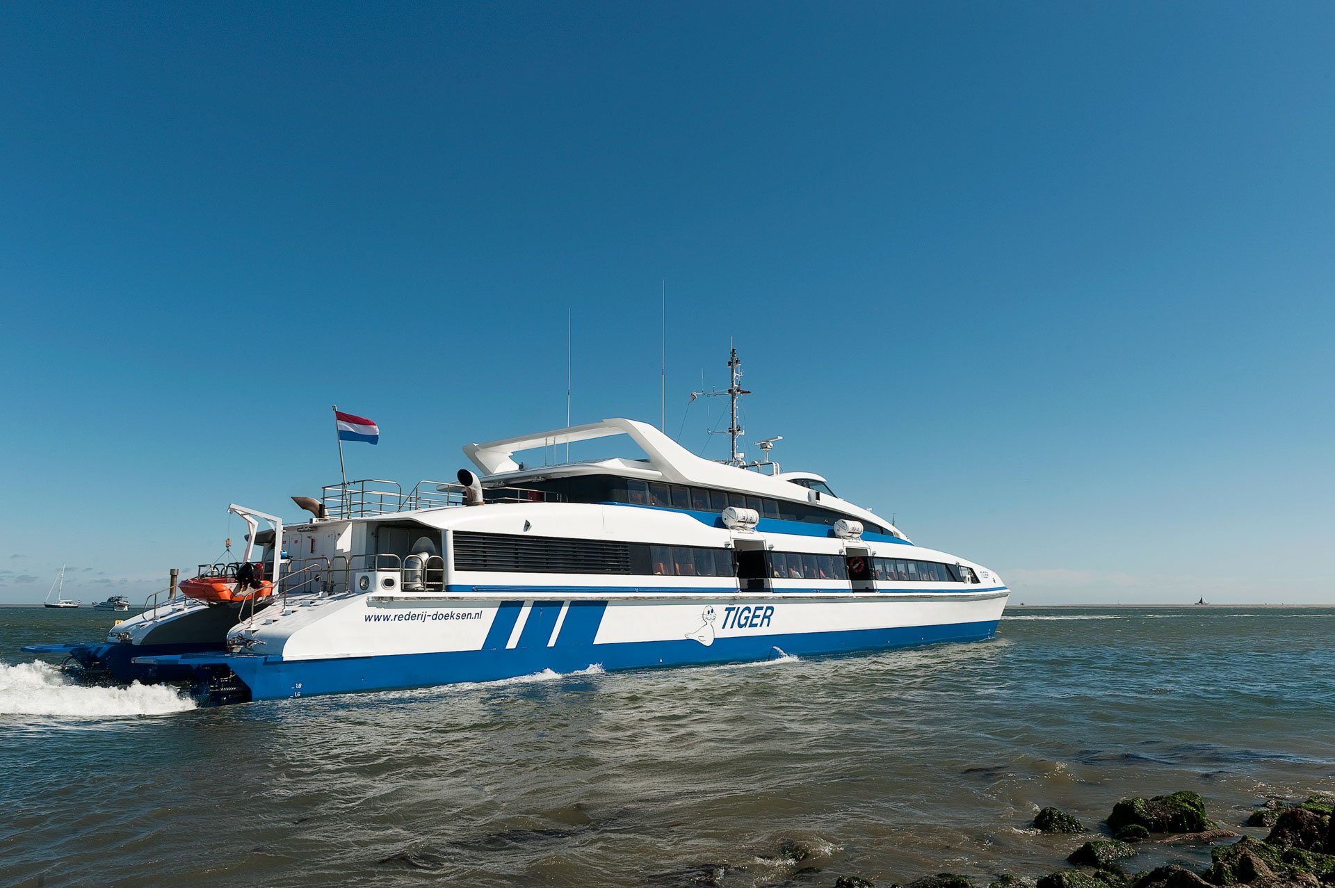Blue and white passenger ferry at sea